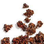Dark chocolate truffles scattered on a white background