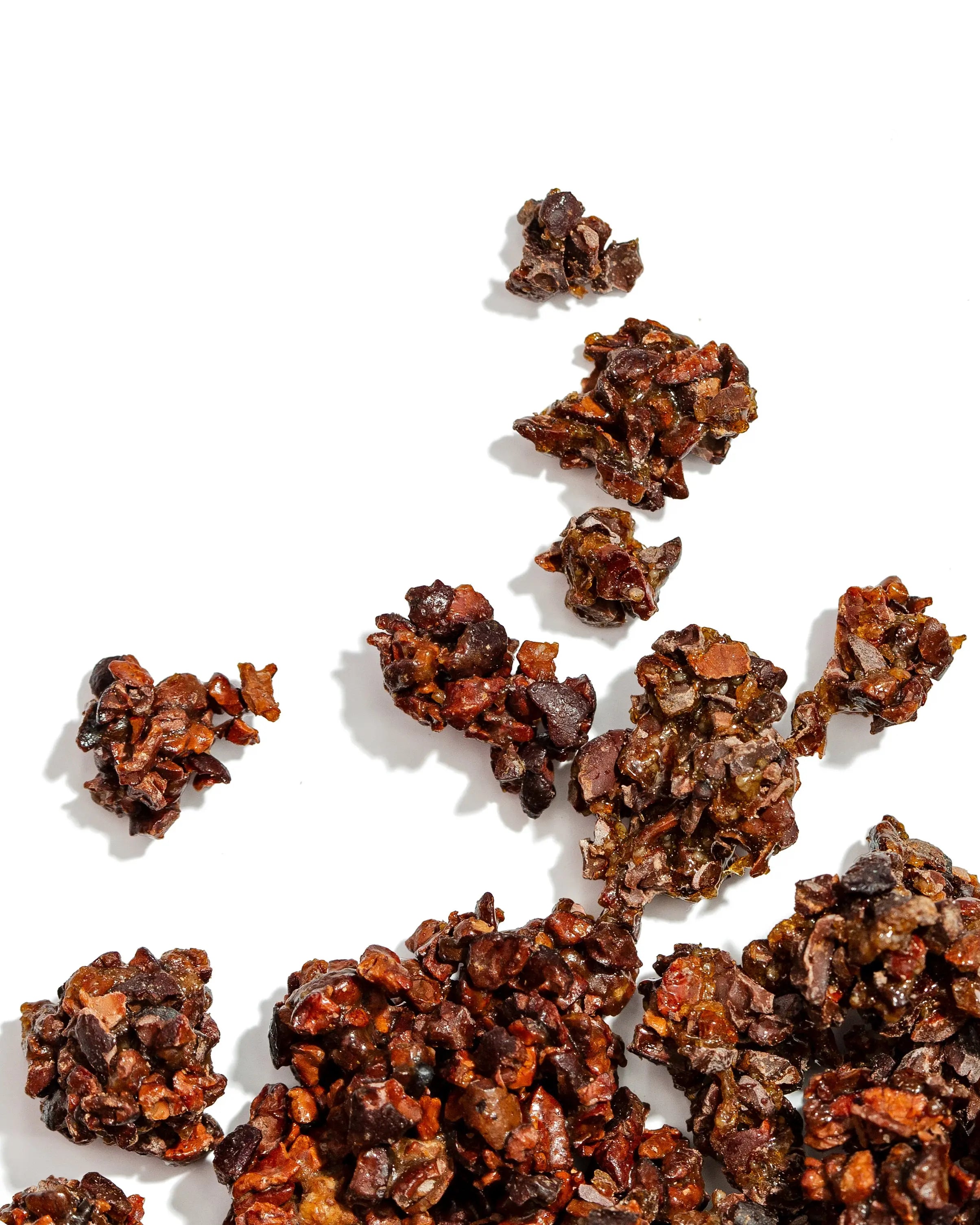 Dark chocolate truffles scattered on a white background